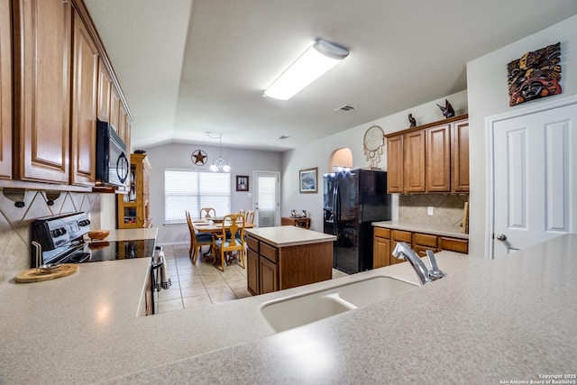 703 Point Spgs, San Antonio, TX 78253 - kitchen with black appliances, a sink, brown cabinets, tasteful backsplash, and a chandelier