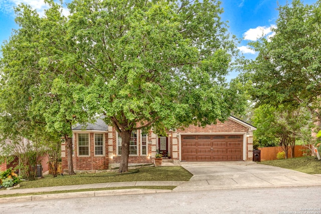 4222 Manitou Bay, San Antonio, TX 78259 - obstructed view of property with brick siding, driveway, and a garage