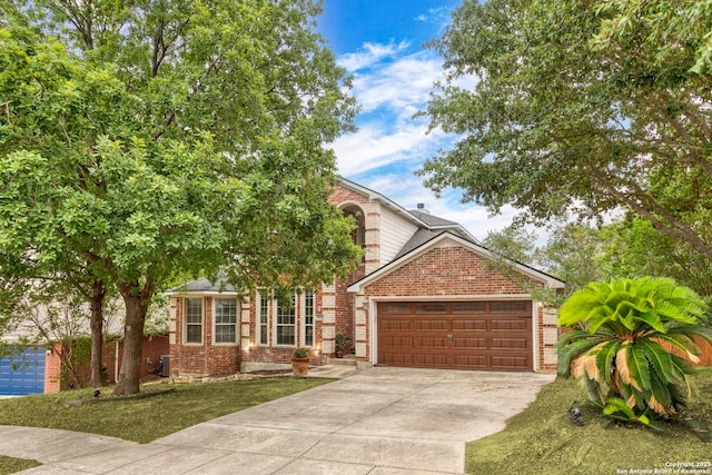 4222 Manitou Bay, San Antonio, TX 78259 - view of property hidden behind natural elements with brick siding, an attached garage, and driveway