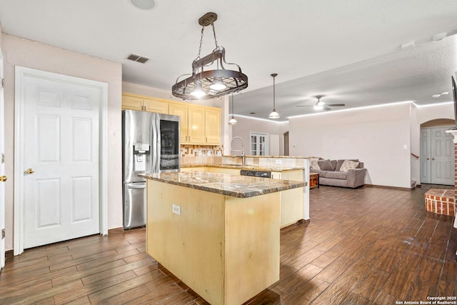 4222 Manitou Bay, San Antonio, TX 78259 - kitchen featuring stainless steel fridge with ice dispenser, arched walkways, a center island, open floor plan, and dark wood finished floors