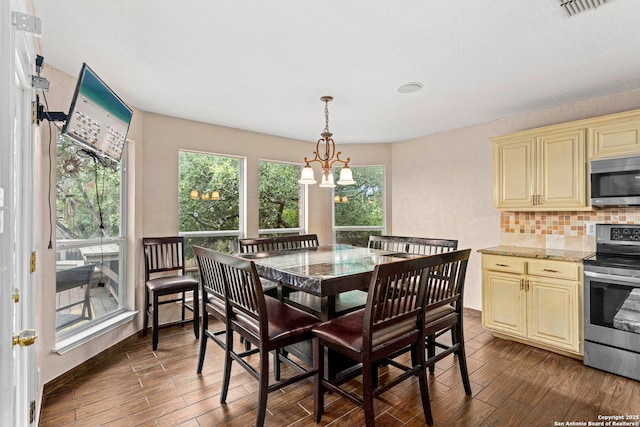 4222 Manitou Bay, San Antonio, TX 78259 - dining room with dark wood-style floors and a chandelier