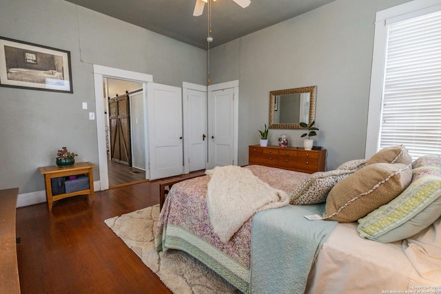 225 W Humphreys, Seguin, TX 78155 - bedroom featuring wood finished floors, ceiling fan, a barn door, and baseboards