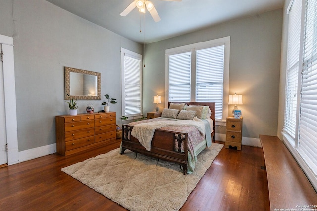 225 W Humphreys, Seguin, TX 78155 - bedroom featuring wood finished floors, multiple windows, baseboards, and a ceiling fan