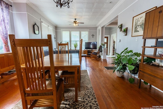 225 W Humphreys, Seguin, TX 78155 - dining room featuring wood finished floors, a ceiling fan, crown molding, and an ornate ceiling