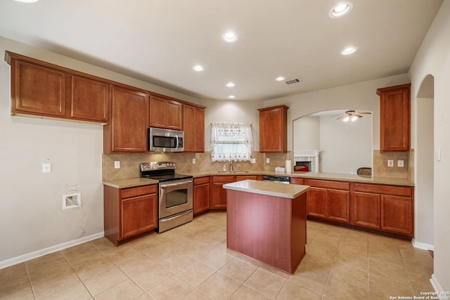 7459 Eagle Ledge, San Antonio, TX 78249 - kitchen with stainless steel appliances, arched walkways, ceiling fan, decorative backsplash, and recessed lighting