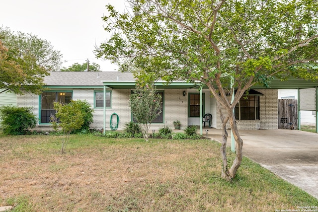 118 Elkins, San Antonio, TX 78226 - view of front facade featuring brick siding, a front lawn, a carport, and driveway