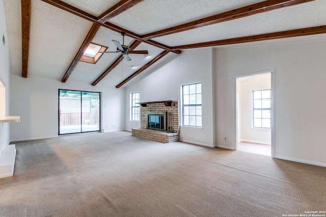 118 Elkins, San Antonio, TX 78226 - unfurnished living room with a brick fireplace, beamed ceiling, ceiling fan, plenty of natural light, and carpet