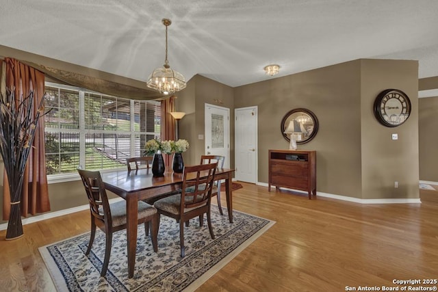 821 Lakeview, Canyon Lake, TX 78133 - dining space featuring a chandelier, baseboards, and wood finished floors