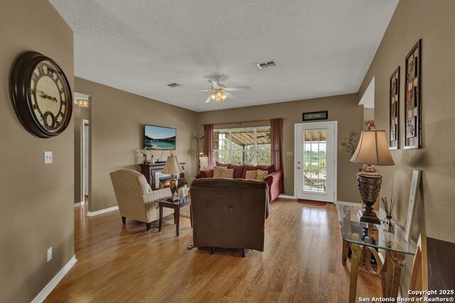821 Lakeview, Canyon Lake, TX 78133 - living room with ceiling fan, wood finished floors, baseboards, and a textured ceiling