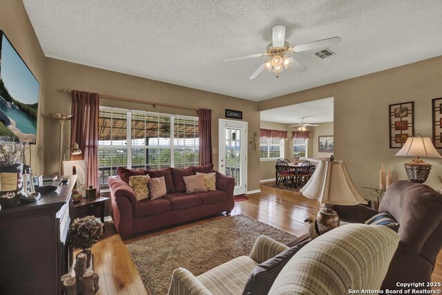 821 Lakeview, Canyon Lake, TX 78133 - living room featuring ceiling fan, wood finished floors, a textured ceiling, and baseboards