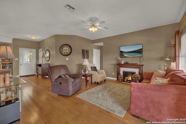 821 Lakeview, Canyon Lake, TX 78133 - living room featuring ceiling fan, light wood-type flooring, a fireplace, and baseboards