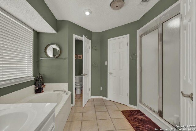 821 Lakeview, Canyon Lake, TX 78133 - bathroom featuring a shower stall, toilet, tile patterned floors, a garden tub, and baseboards