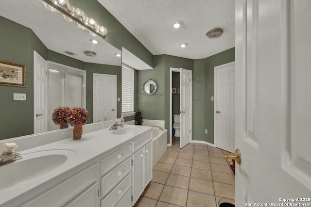 821 Lakeview, Canyon Lake, TX 78133 - full bathroom with double vanity, tile patterned floors, a textured ceiling, toilet, and baseboards