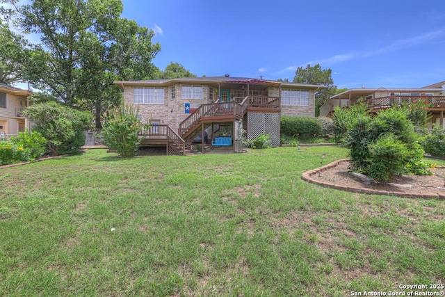 821 Lakeview, Canyon Lake, TX 78133 - back of property with stairway, a deck, and a lawn