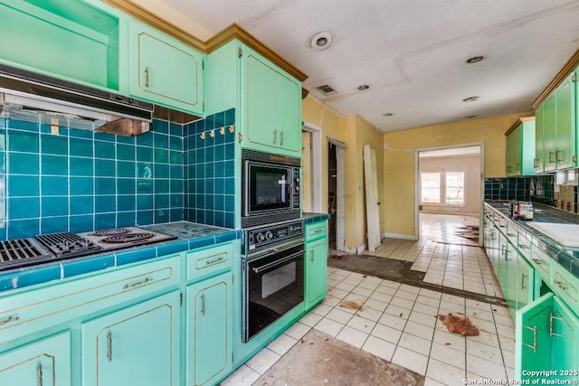 3311 W Commerce St, San Antonio, TX 78228 - kitchen with black appliances, tile countertops, decorative backsplash, light tile patterned floors, and range hood