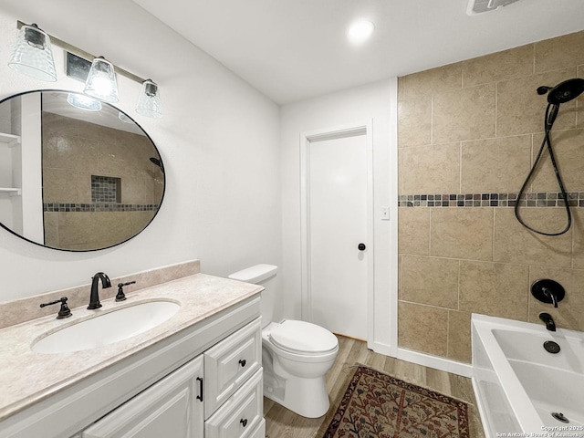 1412 Laurie, Canyon Lake, TX 78133 - full bathroom featuring vanity, toilet, shower / tub combination, and wood finished floors