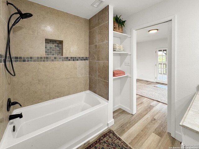 1412 Laurie, Canyon Lake, TX 78133 - full bath featuring wood finished floors, shower / tub combination, and baseboards