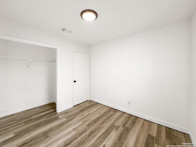 1412 Laurie, Canyon Lake, TX 78133 - unfurnished bedroom with wood finished floors, a closet, and baseboards