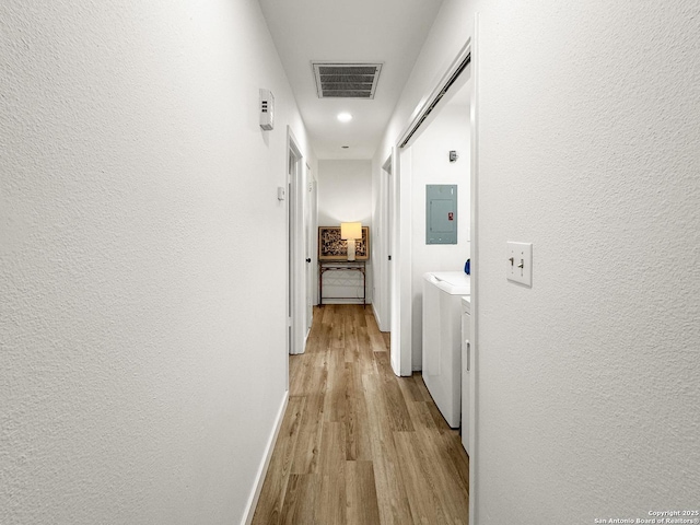 1412 Laurie, Canyon Lake, TX 78133 - hall featuring light wood-style floors, a textured wall, baseboards, electric panel, and recessed lighting