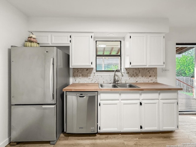 1412 Laurie, Canyon Lake, TX 78133 - kitchen featuring stainless steel appliances, a sink, wood counters, and white cabinets