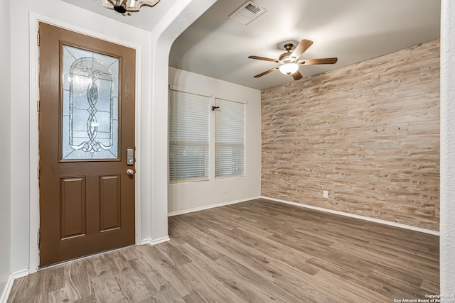 10442 Macarthur, Converse, TX 78109 - entryway with wooden walls, a ceiling fan, wood finished floors, baseboards, and arched walkways