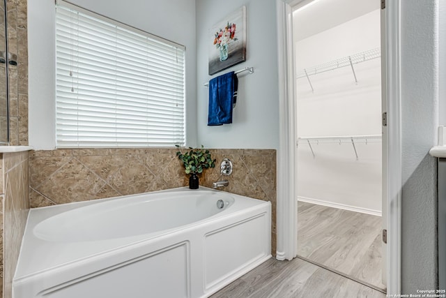 10442 Macarthur, Converse, TX 78109 - bathroom with a bath, wood finished floors, and a walk in closet