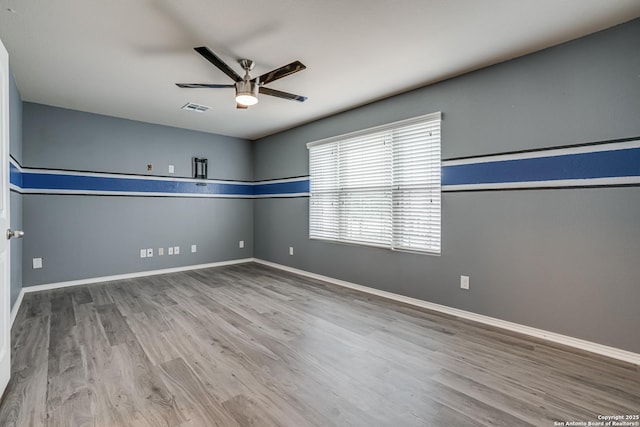 10442 Macarthur, Converse, TX 78109 - unfurnished room featuring ceiling fan, wood finished floors, and baseboards