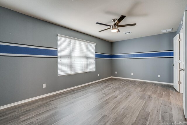 10442 Macarthur, Converse, TX 78109 - empty room featuring ceiling fan, wood finished floors, and baseboards