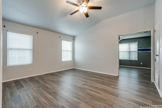 10442 Macarthur, Converse, TX 78109 - empty room featuring a ceiling fan, vaulted ceiling, plenty of natural light, dark wood finished floors, and baseboards