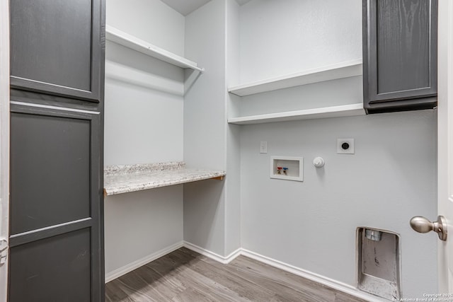 10442 Macarthur, Converse, TX 78109 - laundry area featuring hookup for an electric dryer, cabinet space, wood finished floors, washer hookup, and baseboards