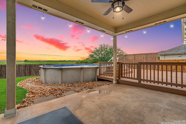 10442 Macarthur, Converse, TX 78109 - patio terrace at dusk with a ceiling fan, a deck, and a patio area