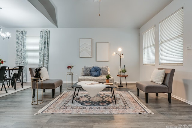 10442 Macarthur, Converse, TX 78109 - living area with baseboards, a chandelier, and wood finished floors