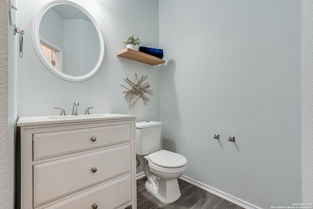 10442 Macarthur, Converse, TX 78109 - half bathroom featuring baseboards, wood finished floors, toilet, and vanity