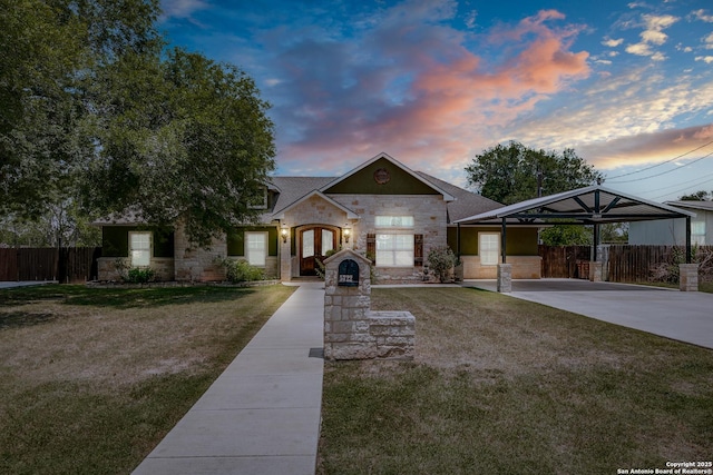 5722 Pioneer Rdg, San Antonio, TX 78245 - view of front of property featuring stone siding, french doors, driveway, and an attached carport