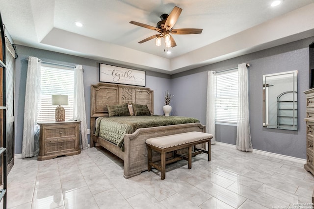 5722 Pioneer Rdg, San Antonio, TX 78245 - bedroom featuring a raised ceiling, recessed lighting, baseboards, a ceiling fan, and light marble finish flooring