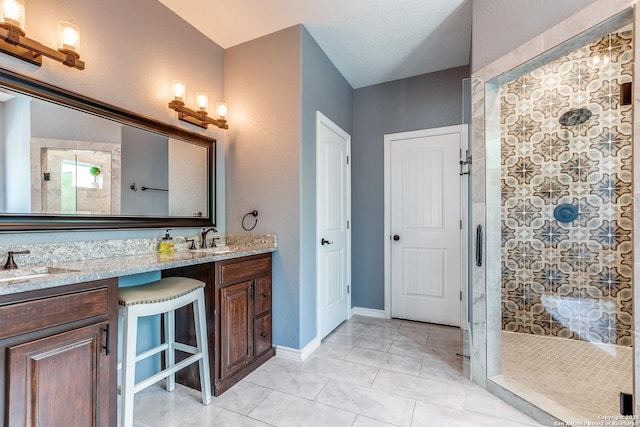 5722 Pioneer Rdg, San Antonio, TX 78245 - bathroom featuring a tile shower, double vanity, and tile patterned flooring