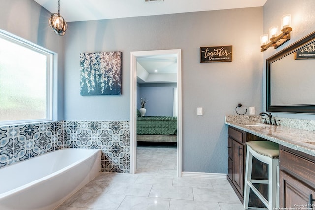 5722 Pioneer Rdg, San Antonio, TX 78245 - full bathroom featuring connected bathroom, a tub to relax in, vanity, marble look tile flooring, and beverage cooler