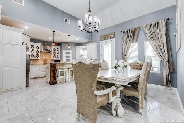 5722 Pioneer Rdg, San Antonio, TX 78245 - dining area featuring a chandelier, light marble finish flooring, and baseboards