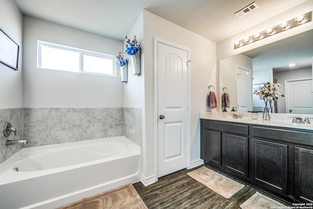 7610 Eclipse Mark, San Antonio, TX 78252 - bathroom with a bath, double vanity, wood finished floors, and baseboards