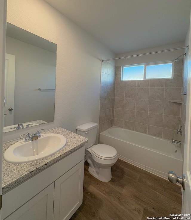 15302 Smoky Honeyeater, San Antonio, TX 78253 - full bathroom featuring wood finished floors, vanity, bathing tub / shower combination, and toilet