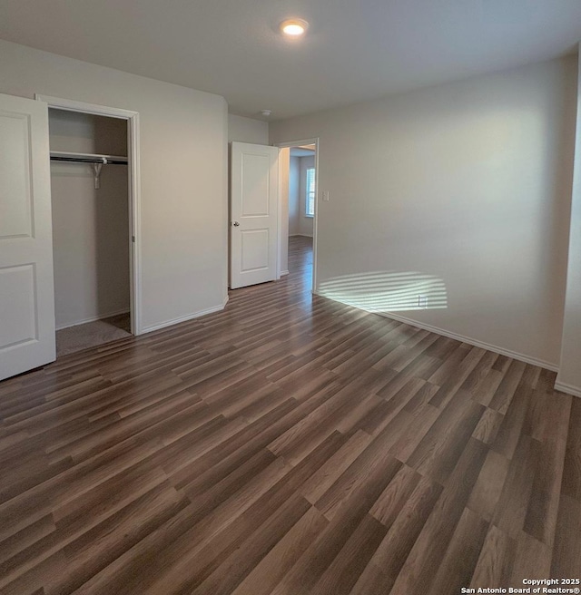 15302 Smoky Honeyeater, San Antonio, TX 78253 - unfurnished bedroom with dark wood-type flooring, baseboards, and a closet