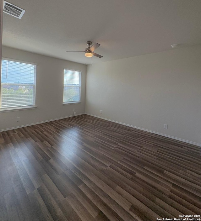 15302 Smoky Honeyeater, San Antonio, TX 78253 - spare room with dark wood-style flooring, a ceiling fan, and baseboards