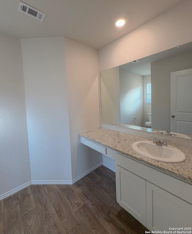 15302 Smoky Honeyeater, San Antonio, TX 78253 - bathroom featuring wood finished floors, toilet, baseboards, and vanity