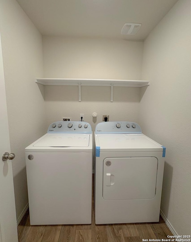 15302 Smoky Honeyeater, San Antonio, TX 78253 - laundry room with independent washer and dryer, wood finished floors, and baseboards