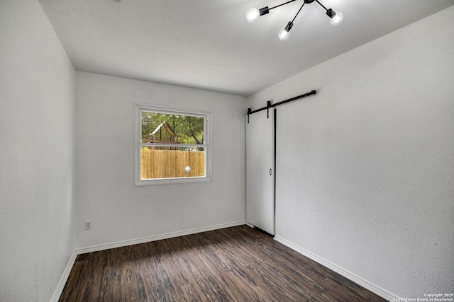 12102 Stoney Cir, San Antonio, TX 78247 - empty room with dark wood finished floors, baseboards, and a barn door