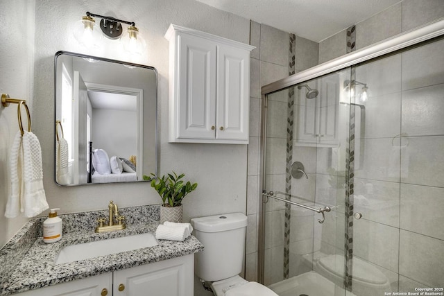 12102 Stoney Cir, San Antonio, TX 78247 - bathroom with toilet, vanity, and a stall shower