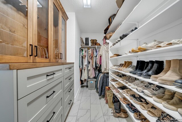104 Bayberry Ct, La Vernia, TX 78121 - walk in closet with light marble finish flooring