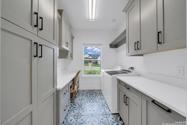 104 Bayberry Ct, La Vernia, TX 78121 - laundry area with washer and clothes dryer, cabinet space, baseboards, and a desk