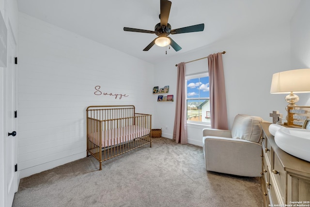 104 Bayberry Ct, La Vernia, TX 78121 - carpeted bedroom featuring a crib and ceiling fan
