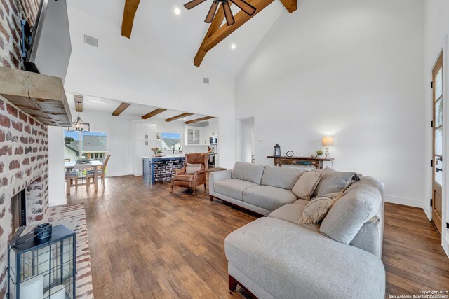104 Bayberry Ct, La Vernia, TX 78121 - living area featuring beam ceiling, ceiling fan, dark wood-style flooring, baseboards, and high vaulted ceiling